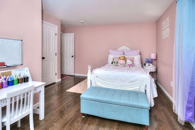 bedroom featuring baseboards and wood finished floors