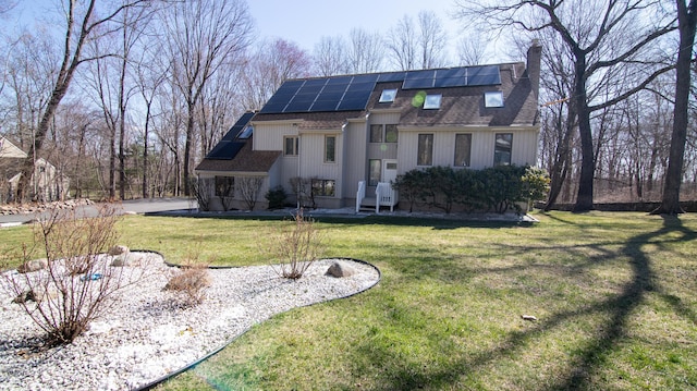 955 Dunbar Hill Rd, Hamden, CT 06514 - view of front of house with roof with shingles, a chimney, roof mounted solar panels, and a front yard