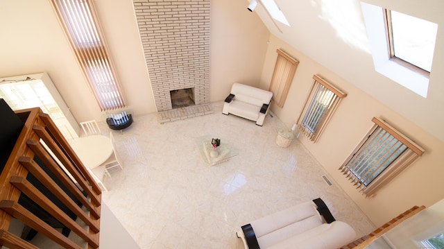 955 Dunbar Hill Rd, Hamden, CT 06514 - living room featuring a towering ceiling, a brick fireplace, and a skylight