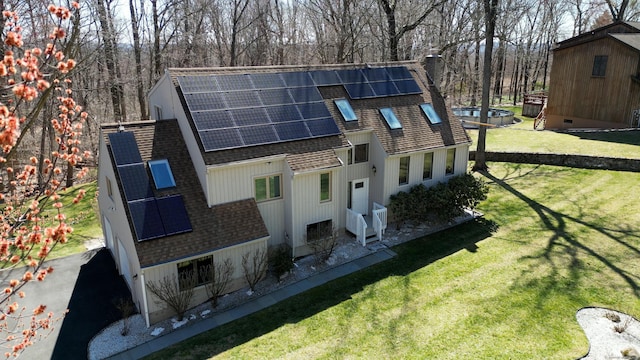 955 Dunbar Hill Rd, Hamden, CT 06514 - back of house with roof with shingles, roof mounted solar panels, and a yard
