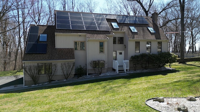 955 Dunbar Hill Rd, Hamden, CT 06514 - view of front facade with roof with shingles, roof mounted solar panels, a front lawn, and a chimney
