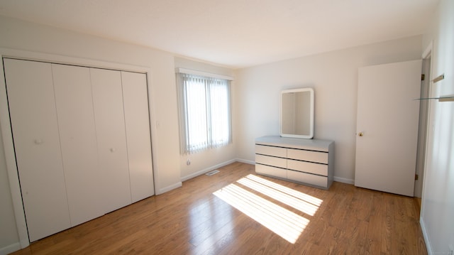 955 Dunbar Hill Rd, Hamden, CT 06514 - unfurnished bedroom with light wood-style flooring, a closet, and baseboards