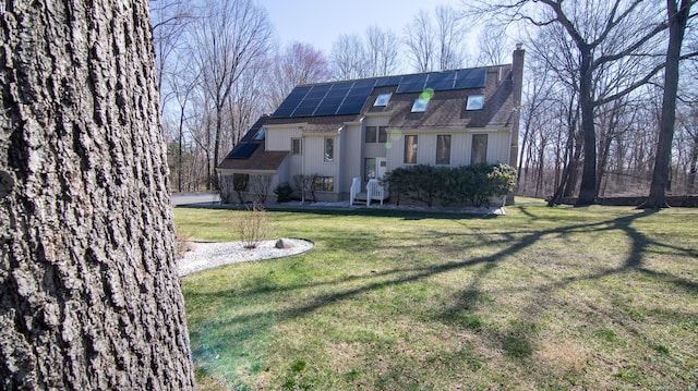 955 Dunbar Hill Rd, Hamden, CT 06514 - view of front property with solar panels, a chimney, a front lawn, and roof with shingles