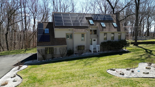 955 Dunbar Hill Rd, Hamden, CT 06514 - view of front of house featuring a shingled roof, roof mounted solar panels, and a front lawn
