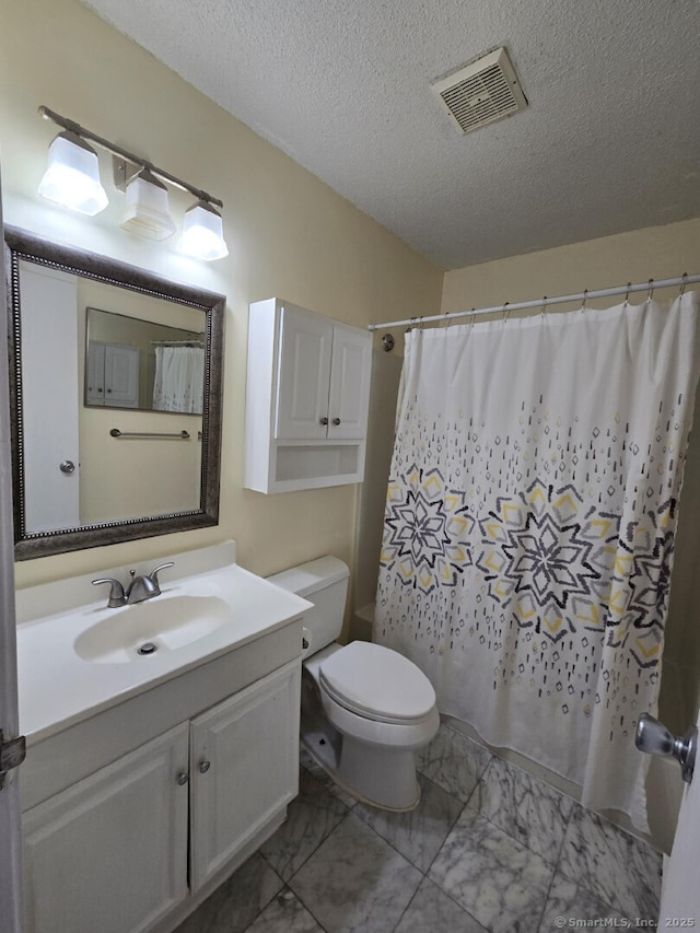 full bathroom featuring a textured ceiling, visible vents, toilet, vanity, and marble finish floor