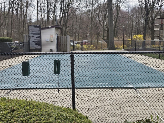 view of swimming pool featuring fence
