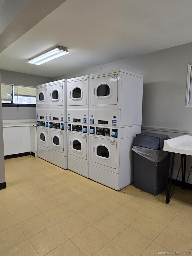 community laundry room with stacked washer and dryer and washer and dryer