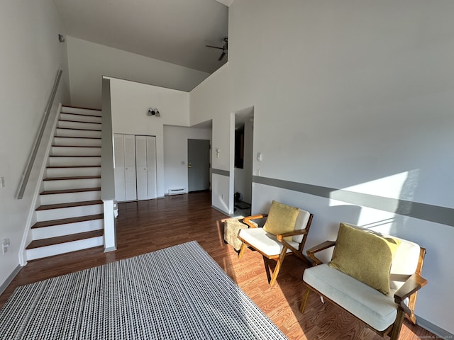 3699 Broadbridge Ave Unit 330, Stratford, CT 06614 - living area with stairs, baseboard heating, wood finished floors, and a towering ceiling