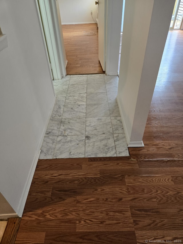 3699 Broadbridge Ave Unit 330, Stratford, CT 06614 - hallway featuring marble look tiles and baseboards