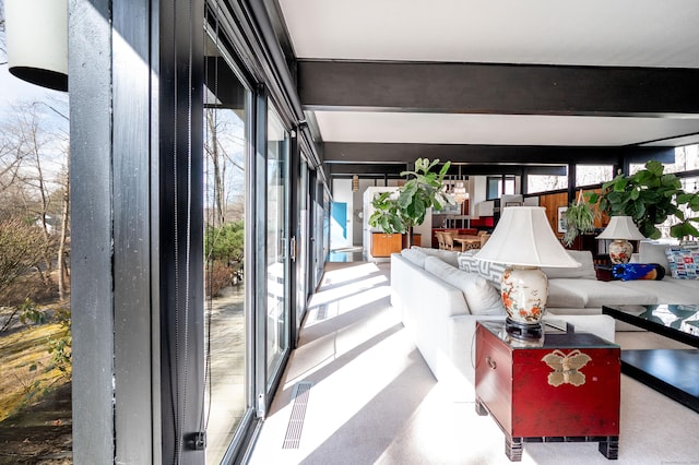 living area with beam ceiling