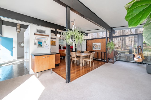 dining area featuring carpet, visible vents, and beamed ceiling