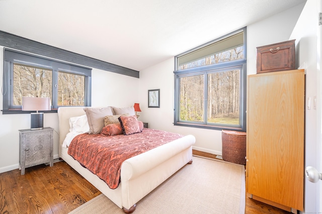 bedroom featuring baseboards and wood finished floors