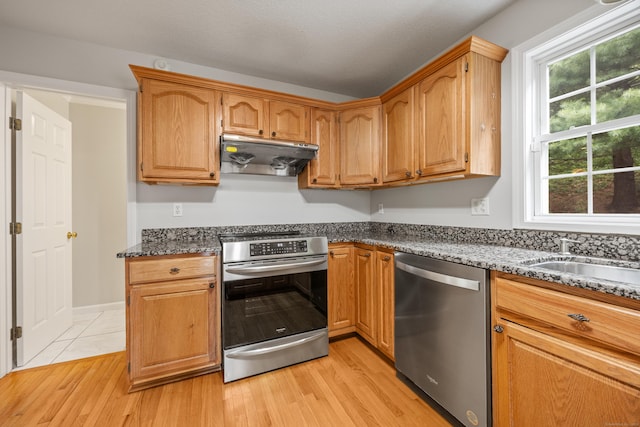 40 Nathan Hale Ct, Cheshire, CT 06410 - kitchen with appliances with stainless steel finishes, under cabinet range hood, light wood-style flooring, a sink, and dark stone counters
