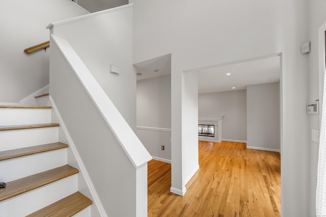 40 Nathan Hale Ct, Cheshire, CT 06410 - stairway with wood finished floors, baseboards, recessed lighting, and a glass covered fireplace