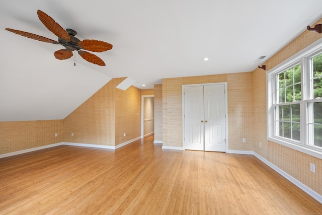 40 Nathan Hale Ct, Cheshire, CT 06410 - unfurnished bedroom with baseboards, light wood-style flooring, brick wall, a closet, and vaulted ceiling