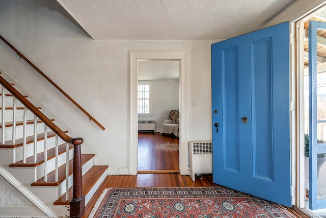 265 Housatonic River Rd, Salisbury, CT 06068 - entryway featuring radiator, hardwood / wood-style floors, and stairway