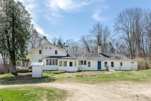 265 Housatonic River Rd, Salisbury, CT 06068 - rear view of property featuring a chimney, dirt driveway, an outdoor structure, a storage unit, and a yard