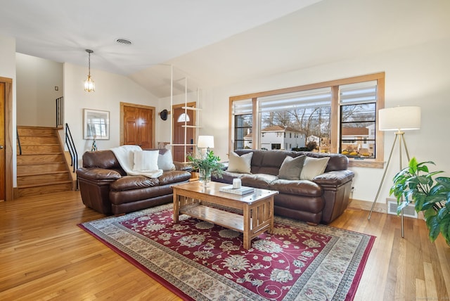 93 Lyman Rd, West Hartford, CT 06117 - living area with light wood-style floors, vaulted ceiling, visible vents, and stairs
