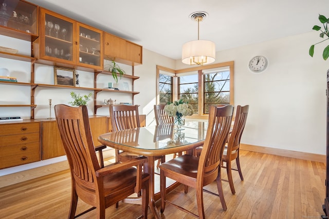 93 Lyman Rd, West Hartford, CT 06117 - dining space featuring baseboards, a notable chandelier, and light wood-style floors
