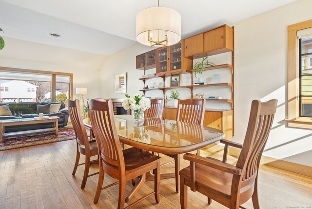 93 Lyman Rd, West Hartford, CT 06117 - dining area featuring visible vents, vaulted ceiling, and light wood-type flooring
