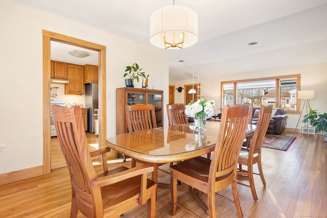 93 Lyman Rd, West Hartford, CT 06117 - dining space featuring visible vents, baseboards, vaulted ceiling, and light wood-type flooring