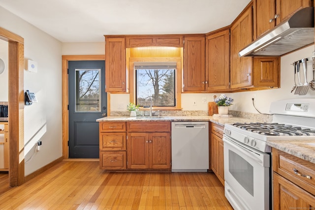 93 Lyman Rd, West Hartford, CT 06117 - kitchen featuring a sink, brown cabinets, white appliances, light wood-style flooring, and under cabinet range hood