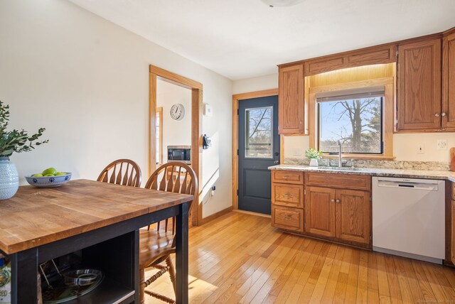 93 Lyman Rd, West Hartford, CT 06117 - kitchen with light wood-type flooring, dishwasher, brown cabinetry, and a sink