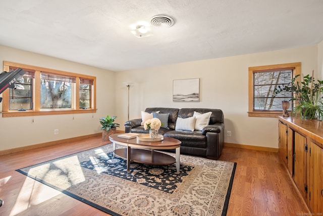 93 Lyman Rd, West Hartford, CT 06117 - living area with baseboards, visible vents, and light wood-style floors