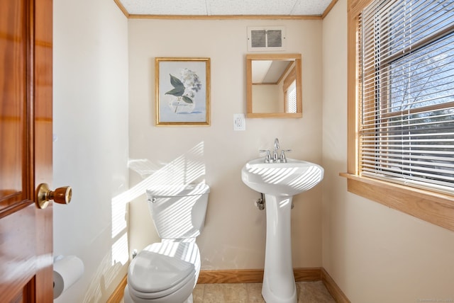 93 Lyman Rd, West Hartford, CT 06117 - bathroom featuring crown molding, a sink, baseboards, toilet, and visible vents
