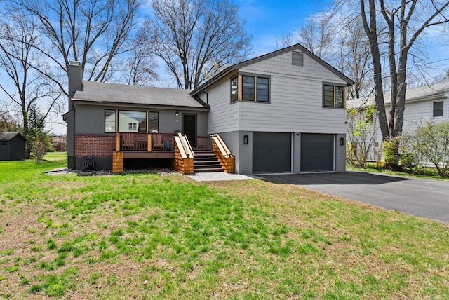 93 Lyman Rd, West Hartford, CT 06117 - split level home with driveway, a chimney, a front yard, an attached garage, and brick siding