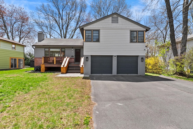 93 Lyman Rd, West Hartford, CT 06117 - split level home featuring a front lawn, a garage, driveway, a chimney, and stucco siding