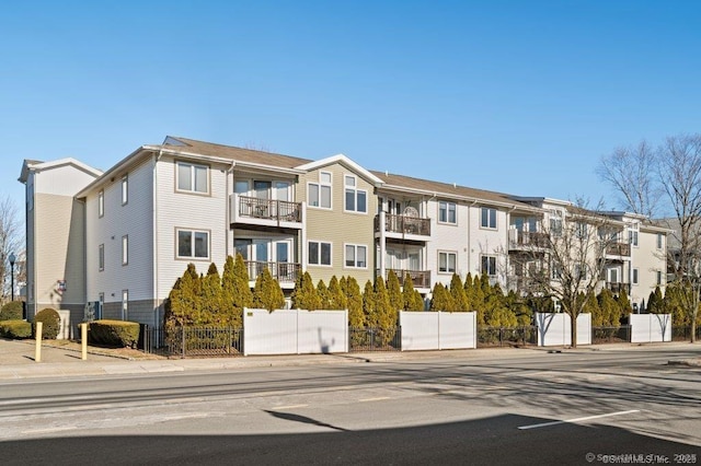view of building exterior with fence