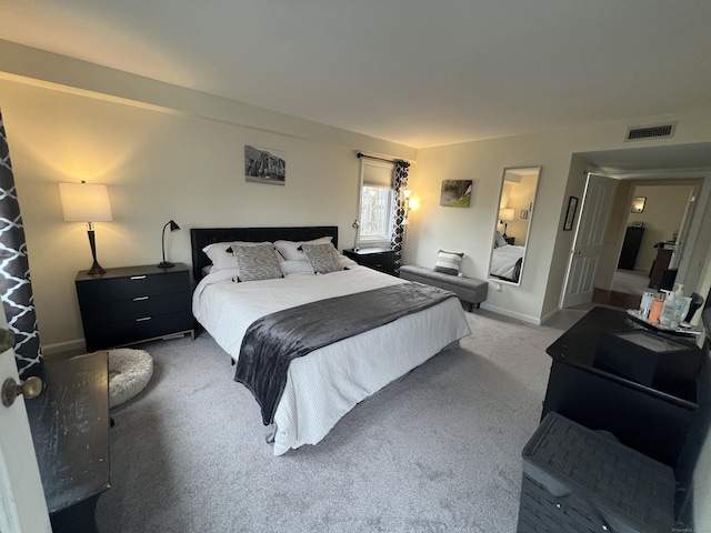 carpeted bedroom with baseboards and visible vents