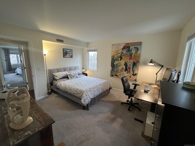 carpeted bedroom with baseboards and visible vents