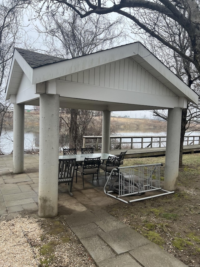 surrounding community featuring a water view, a gazebo, and a patio area