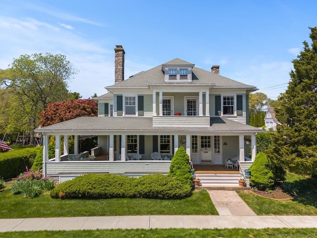 86 Tyler Ave, Groton, CT 06340 - view of front of property with a chimney, covered porch, roof with shingles, and a front lawn