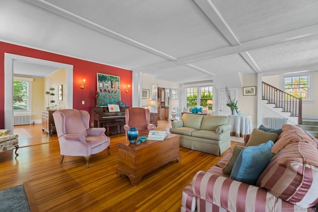 86 Tyler Ave, Groton, CT 06340 - living room featuring radiator heating unit, wood finished floors, stairs, and beamed ceiling