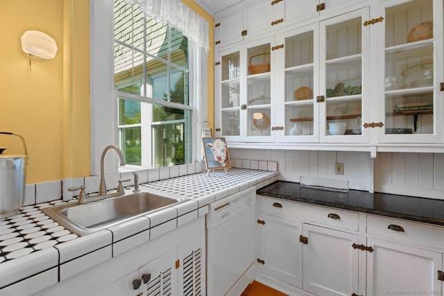 86 Tyler Ave, Groton, CT 06340 - kitchen with white dishwasher, white cabinets, a sink, and glass insert cabinets