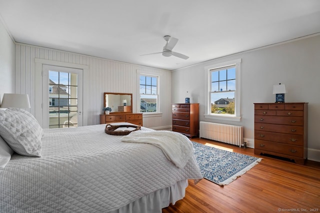 86 Tyler Ave, Groton, CT 06340 - bedroom with radiator heating unit, wood finished floors, multiple windows, ornamental molding, and ceiling fan
