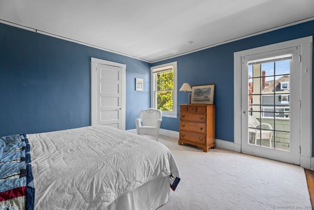 86 Tyler Ave, Groton, CT 06340 - carpeted bedroom featuring baseboards, access to exterior, and crown molding