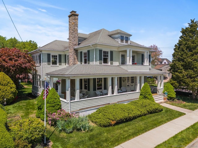 86 Tyler Ave, Groton, CT 06340 - view of front of house with a chimney, a shingled roof, a porch, and a front lawn