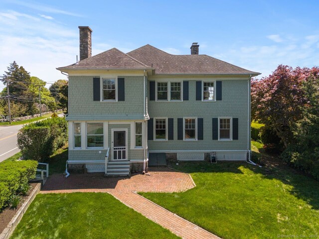 86 Tyler Ave, Groton, CT 06340 - view of front facade with a chimney, a front lawn, and a shingled roof