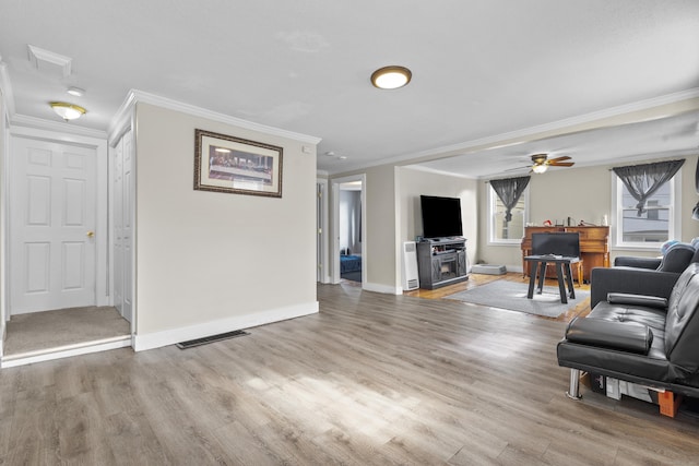 living area featuring baseboards, visible vents, and light wood-style flooring