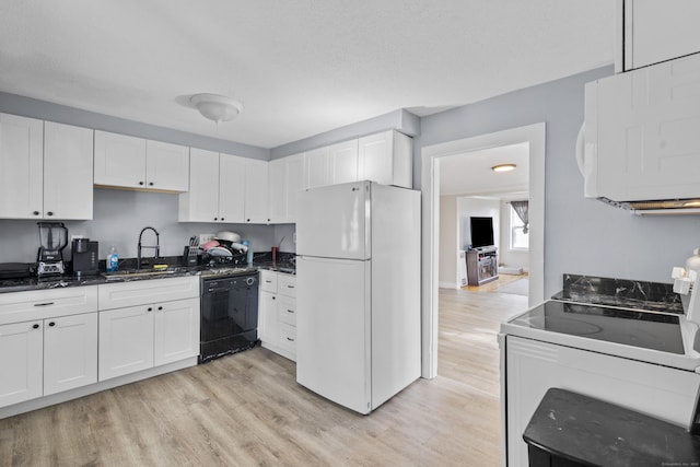 kitchen with white appliances, white cabinetry, light wood-style floors, and a sink