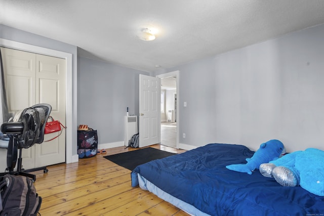 bedroom featuring baseboards and hardwood / wood-style floors