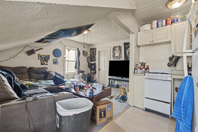 living area with a textured ceiling and light tile patterned floors