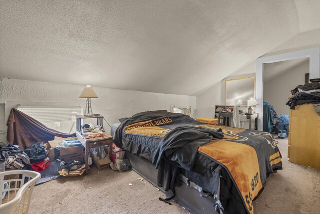 bedroom with a textured ceiling, carpet flooring, and lofted ceiling