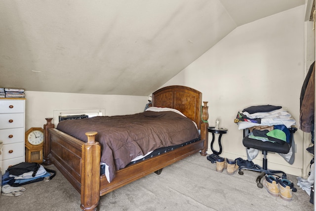bedroom with vaulted ceiling and carpet