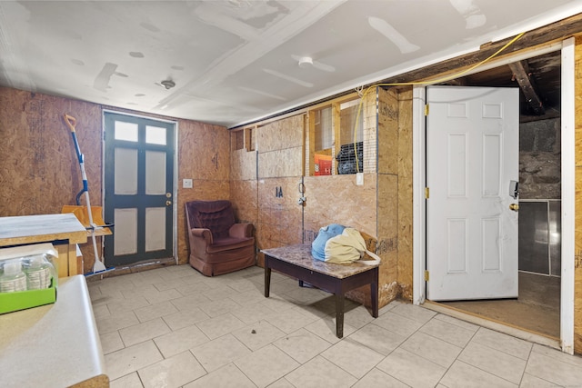 living area featuring wood walls