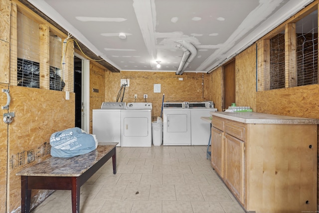 laundry room with washing machine and clothes dryer and cabinet space